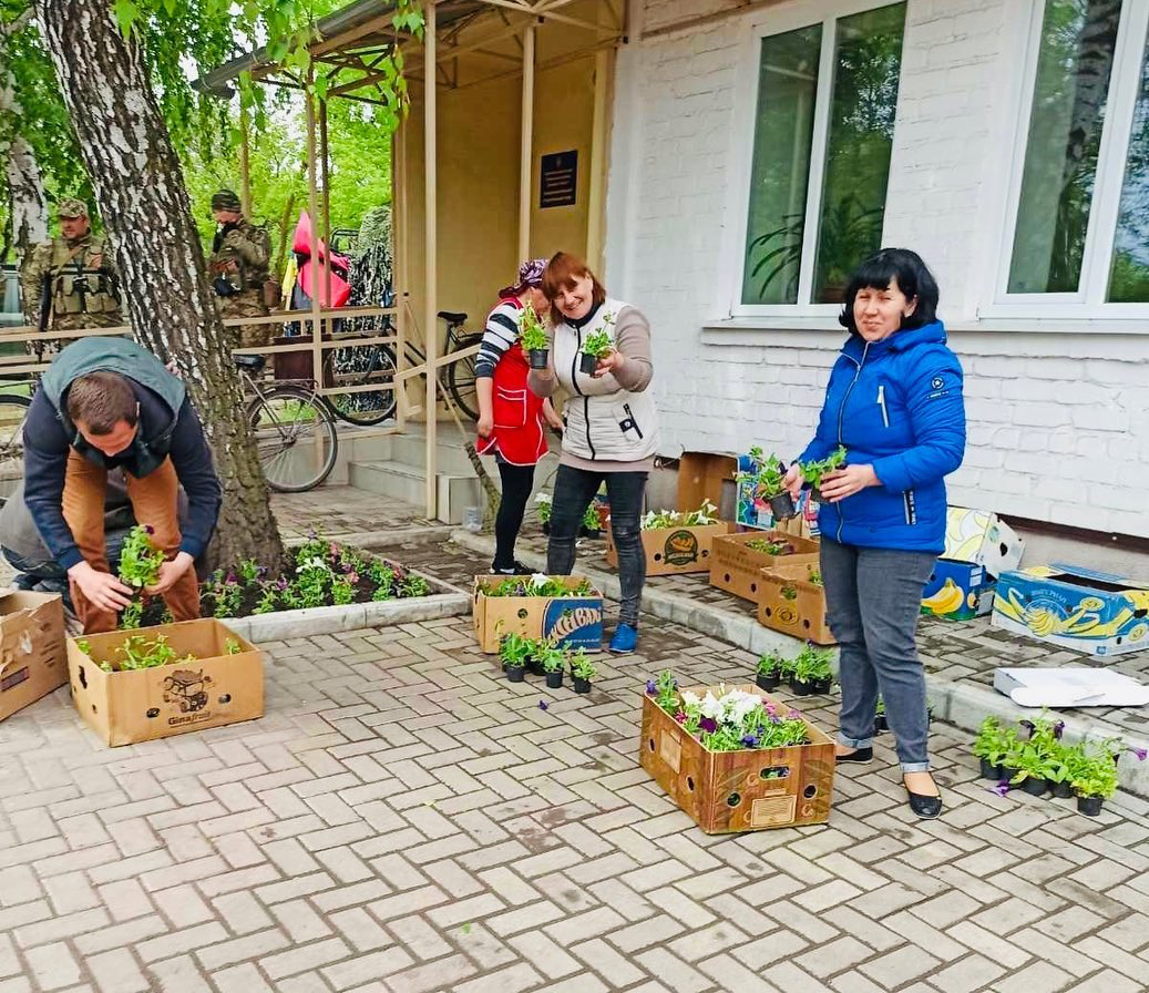 Employees of communal enterprises planting flowers 