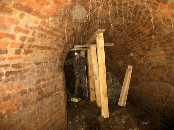 A fragment of an underground passage. Red brick masonry.
