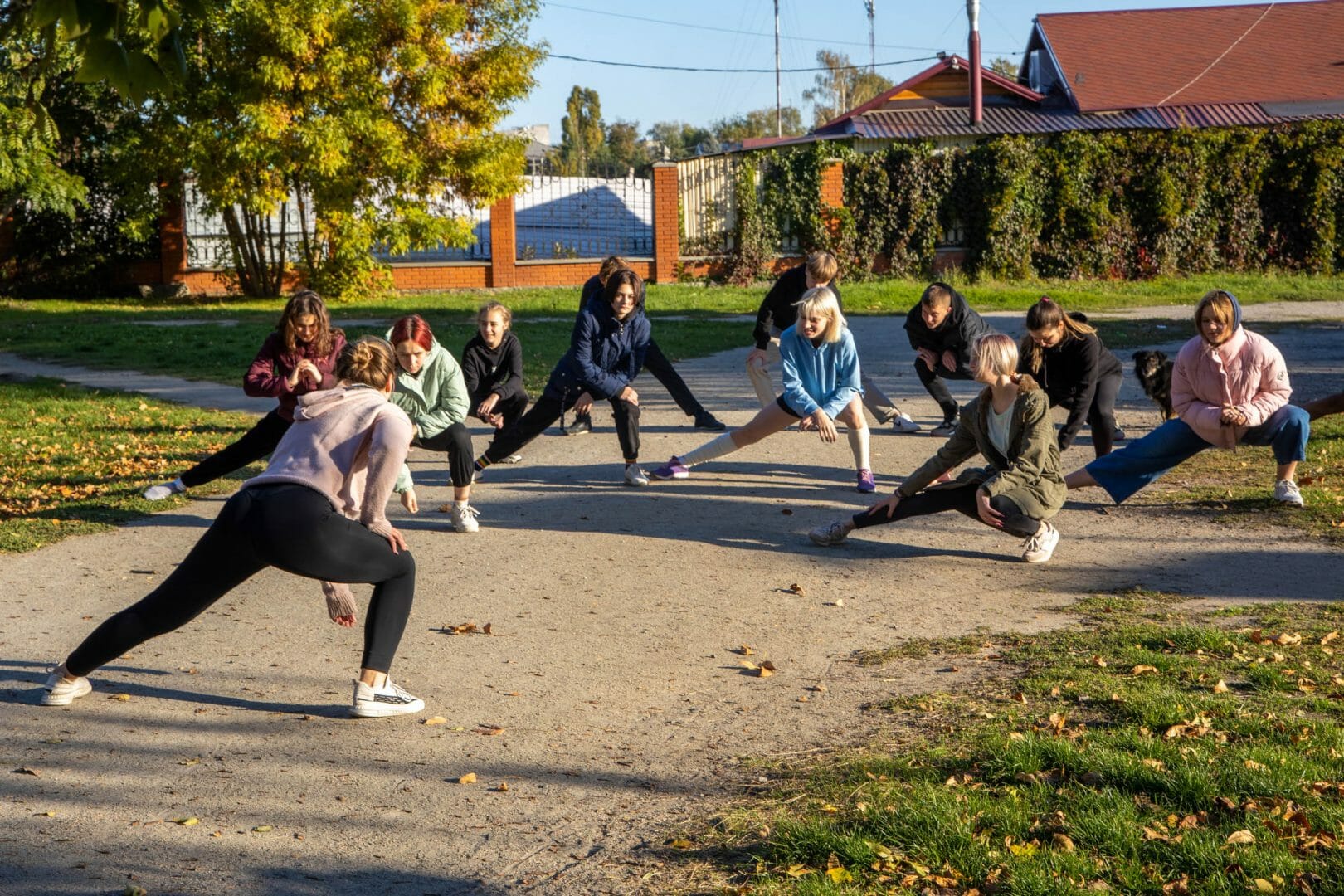 Pupils of a local school have physical education classes in the park. 