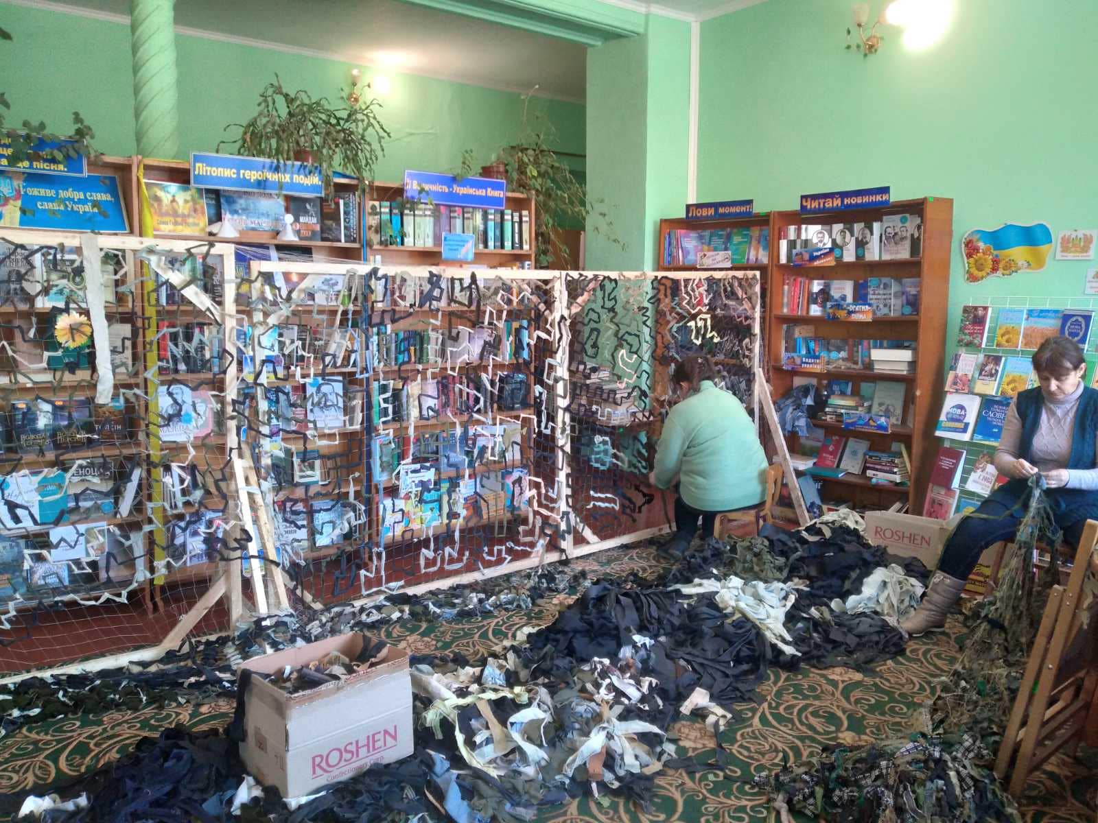 Volunteers weaving camouflage nets 
