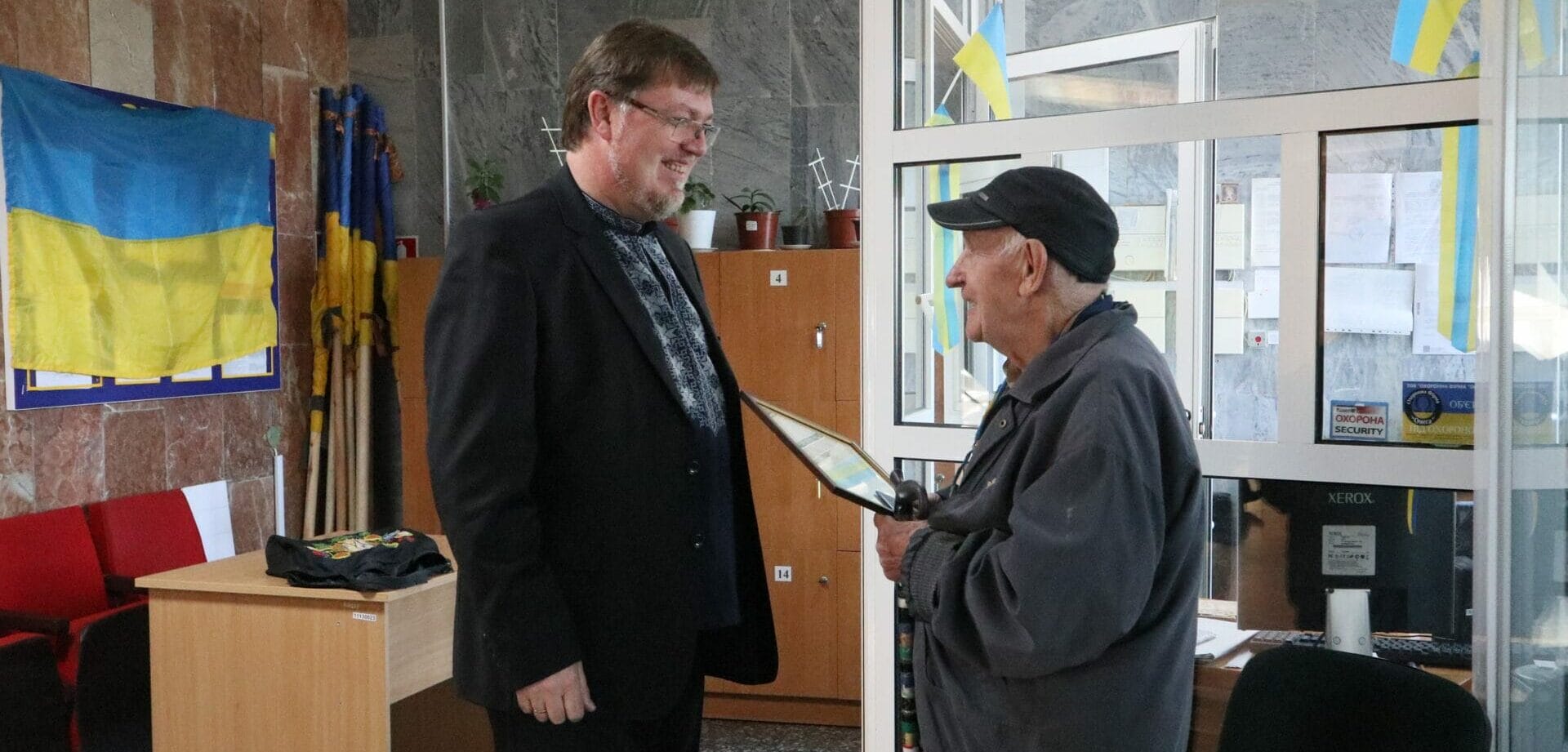 Mayor Oleksandr Menzul and 87-year-old volunteer Viacheslav Naydenov