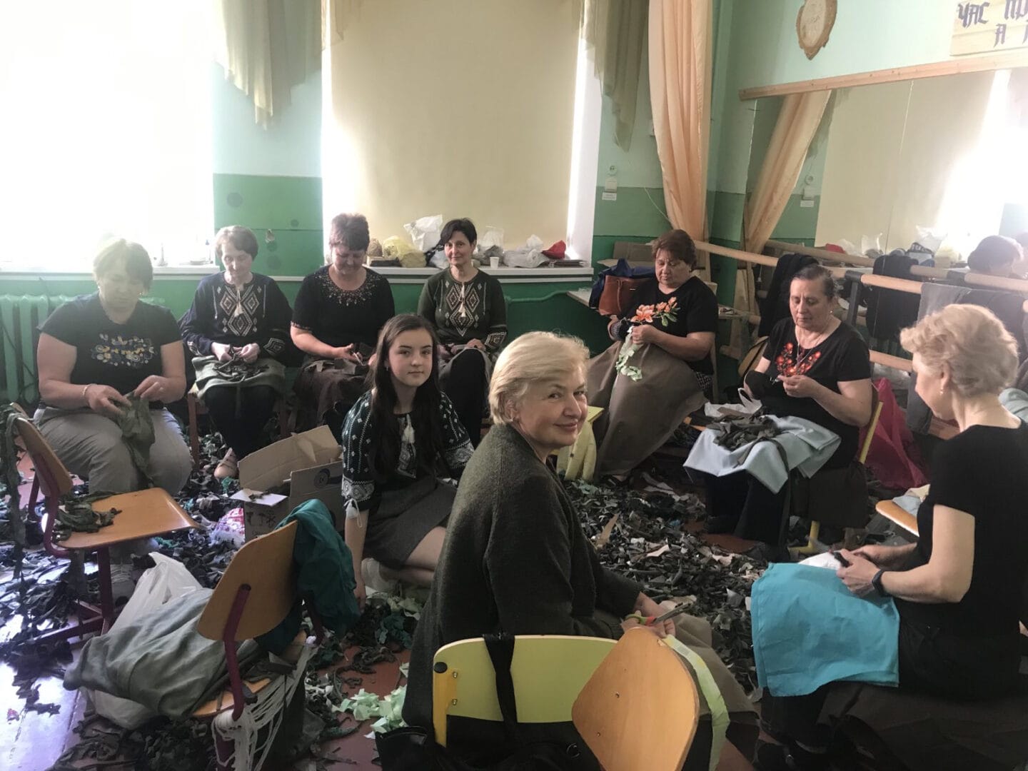 The women’s volunteer team of the Kovalivka Lyceum weaves camouflage nets for the military
