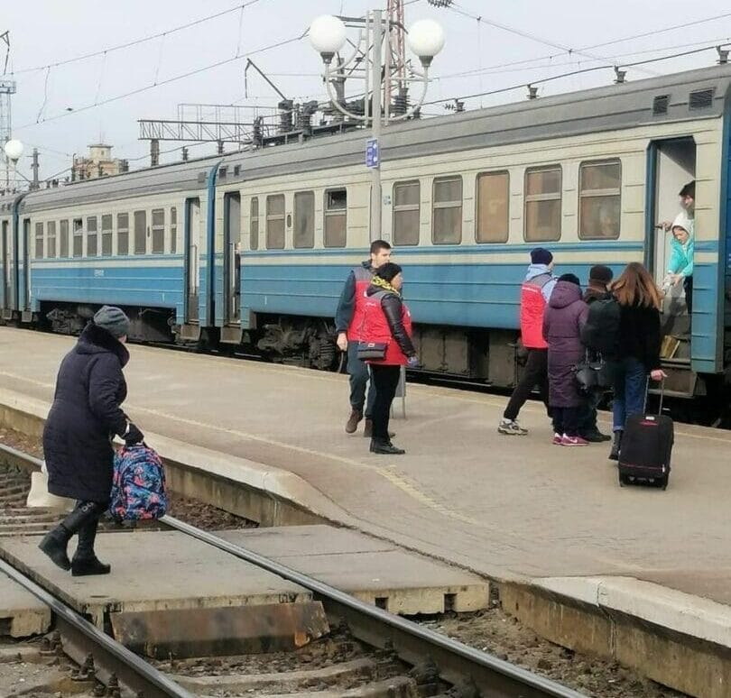 Youth council volunteers distribute hot tea and sandwiches to passengers at the Koziatyn railway station