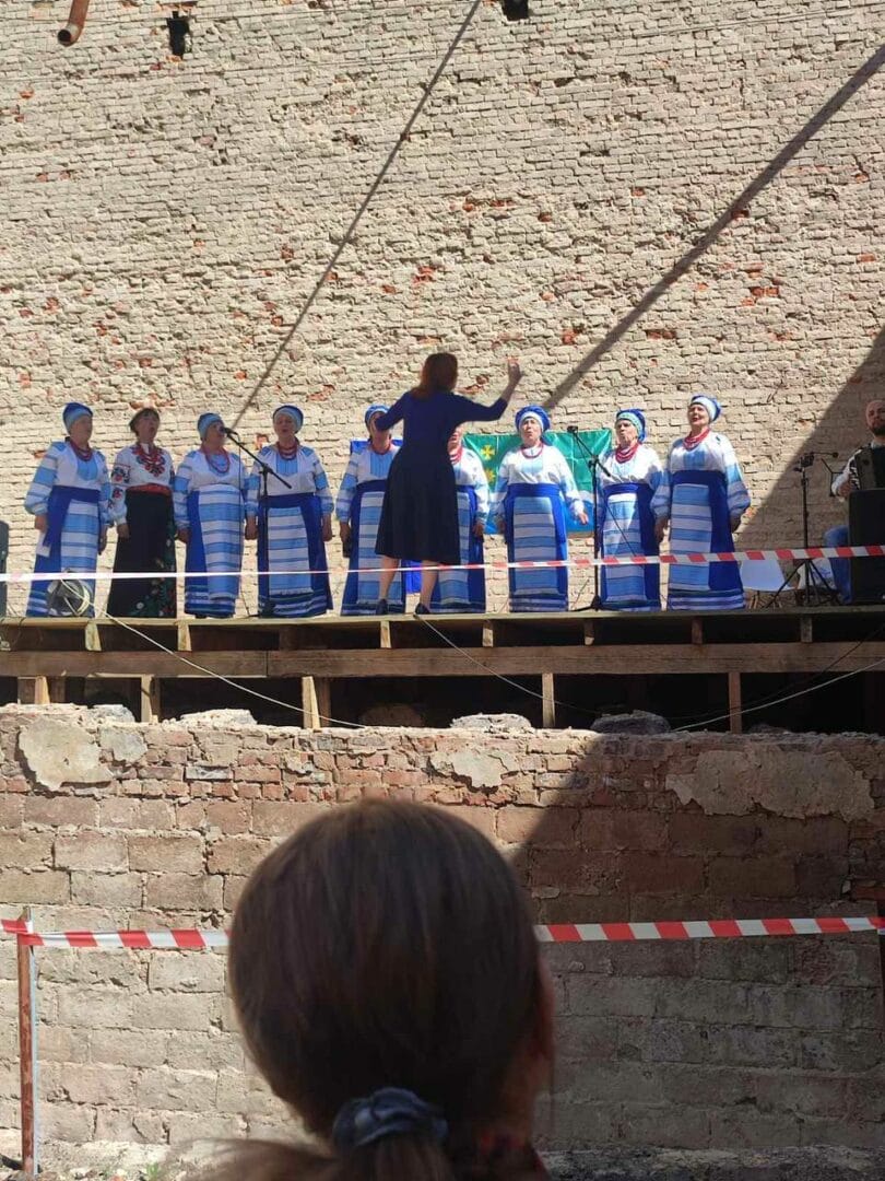 Performance of an ensemble on the stage of the destroyed Culture Centre in Ivanivka