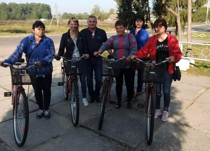 Social workers on bicycles purchased with the Community funds