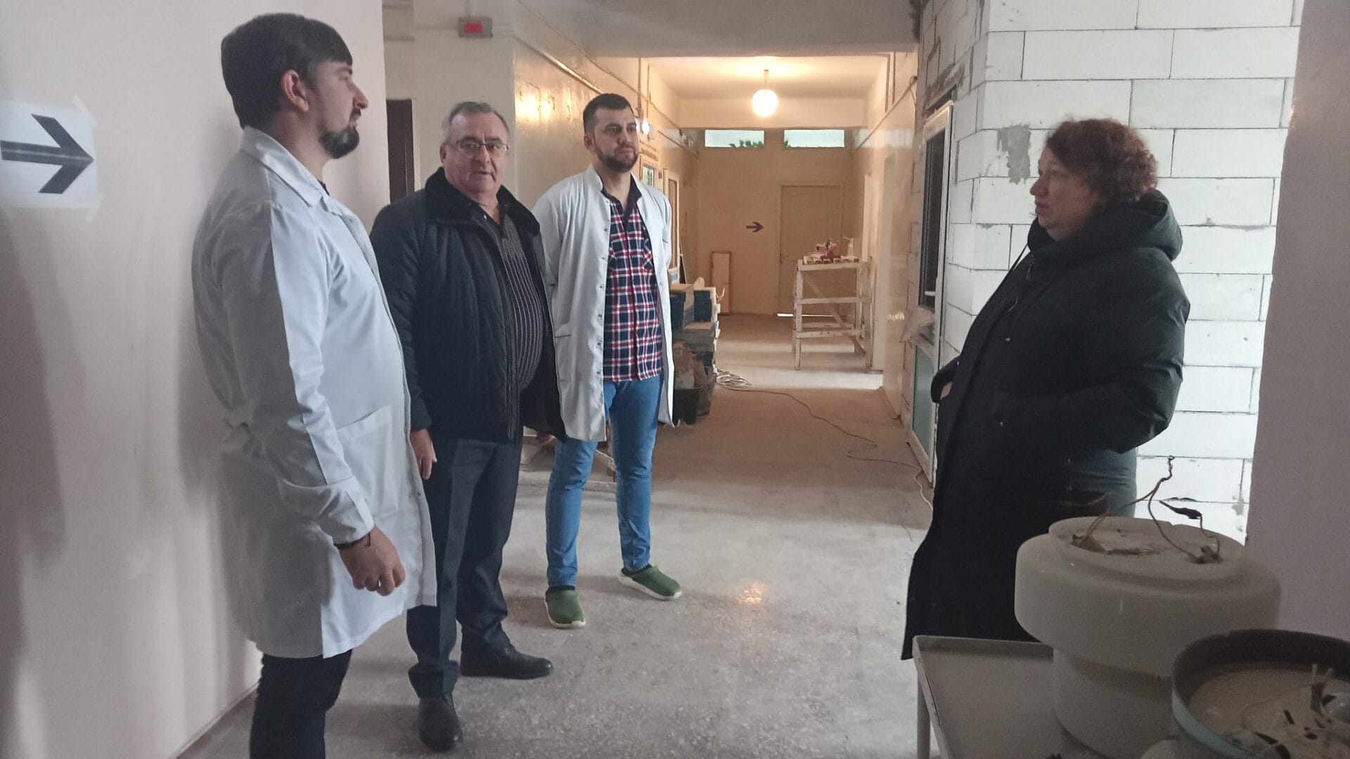 Community Head and colleagues visiting a facility