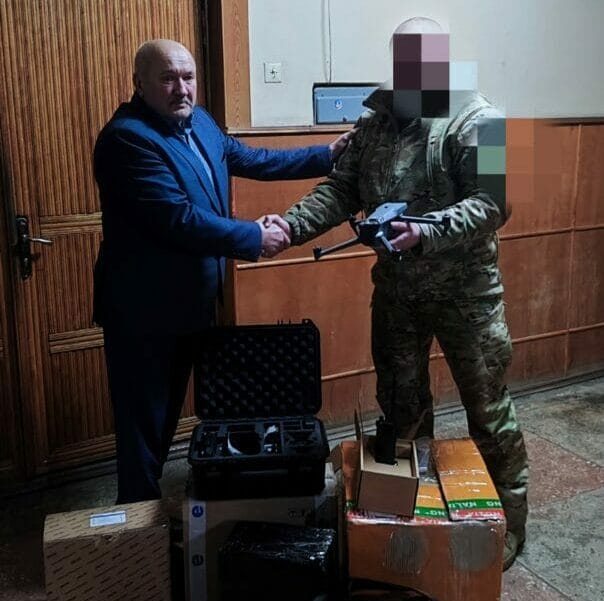 Community Head Volodymyr Tiron handing over drones to a serviceman