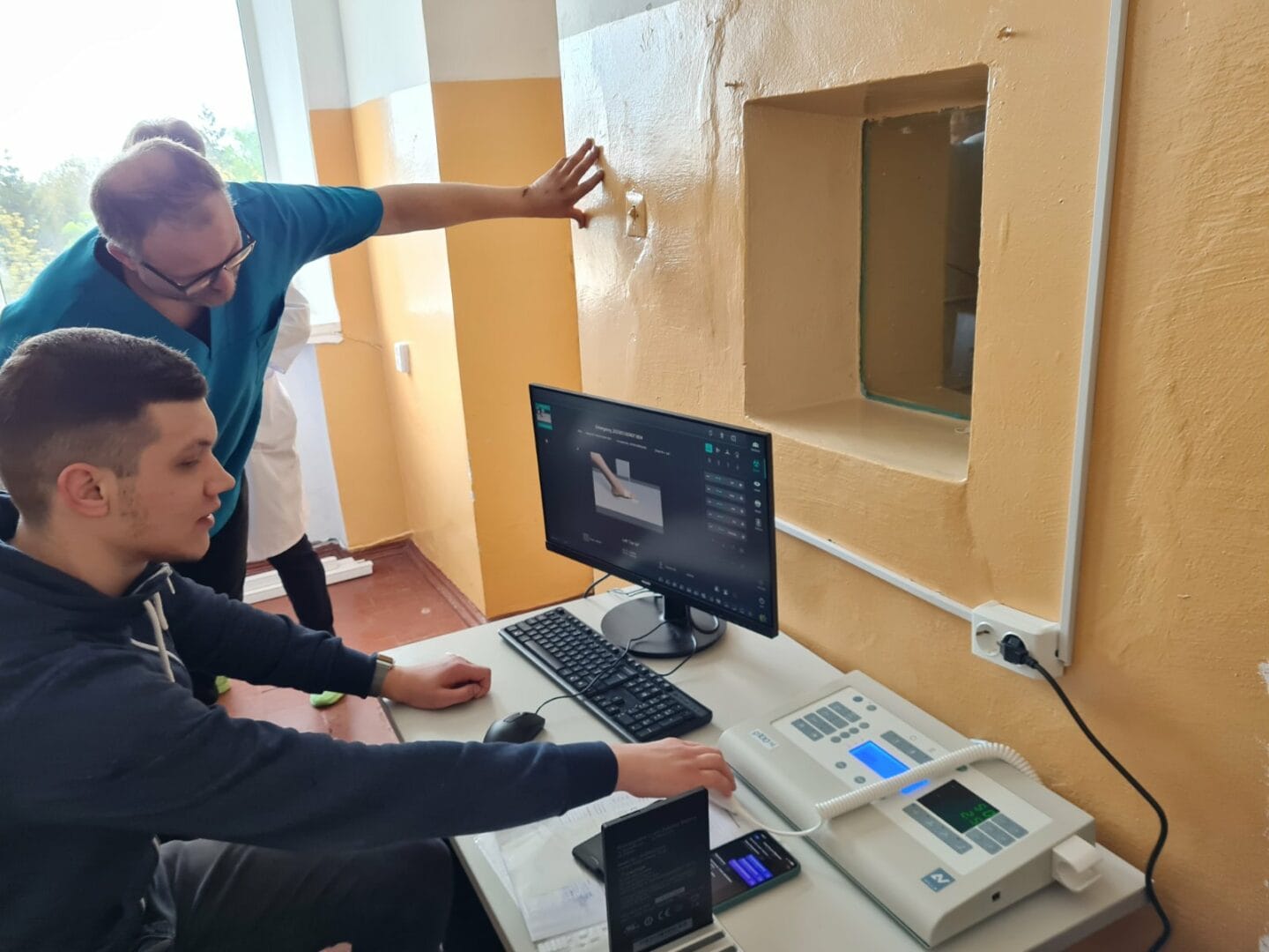  The employees of the Kamianka Multidisciplinary Hospital learning the design and operation of the X-ray machine