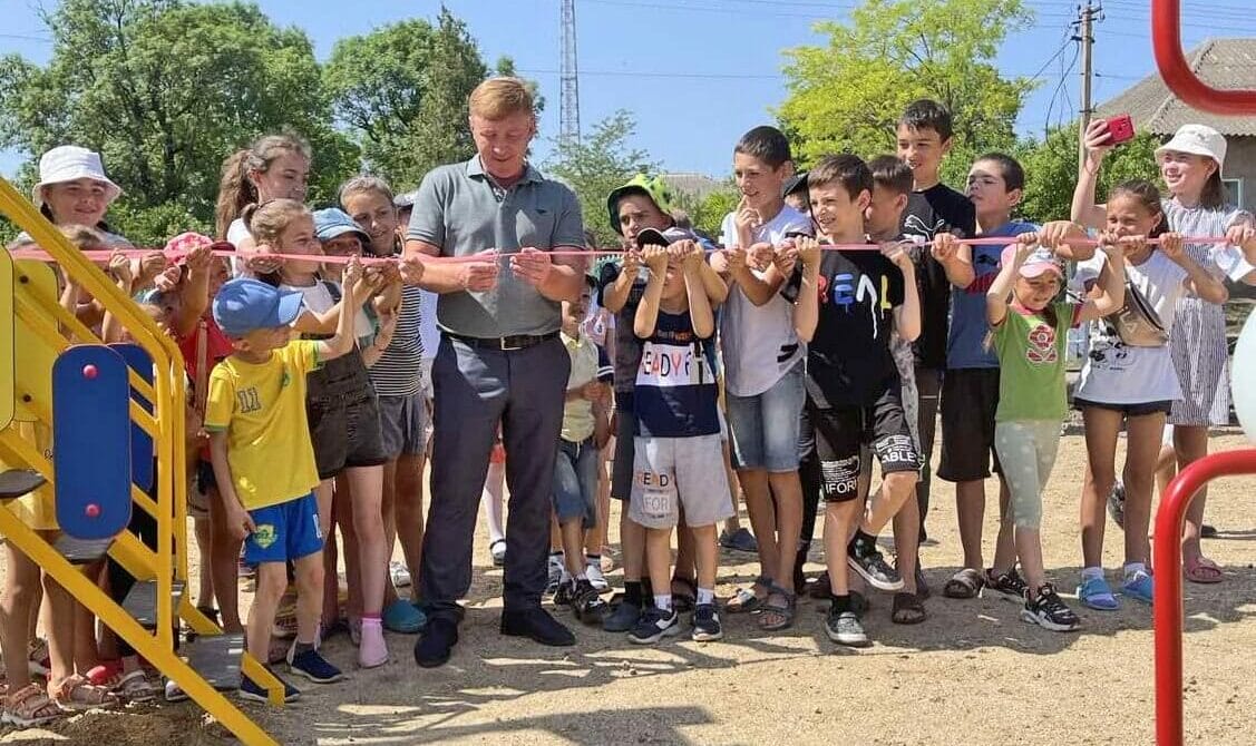 Community Head (in the centre of the first photo) opening a playground with the children