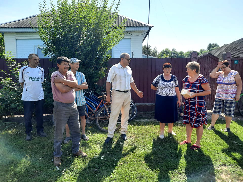 The head of the community (in the center) with residents