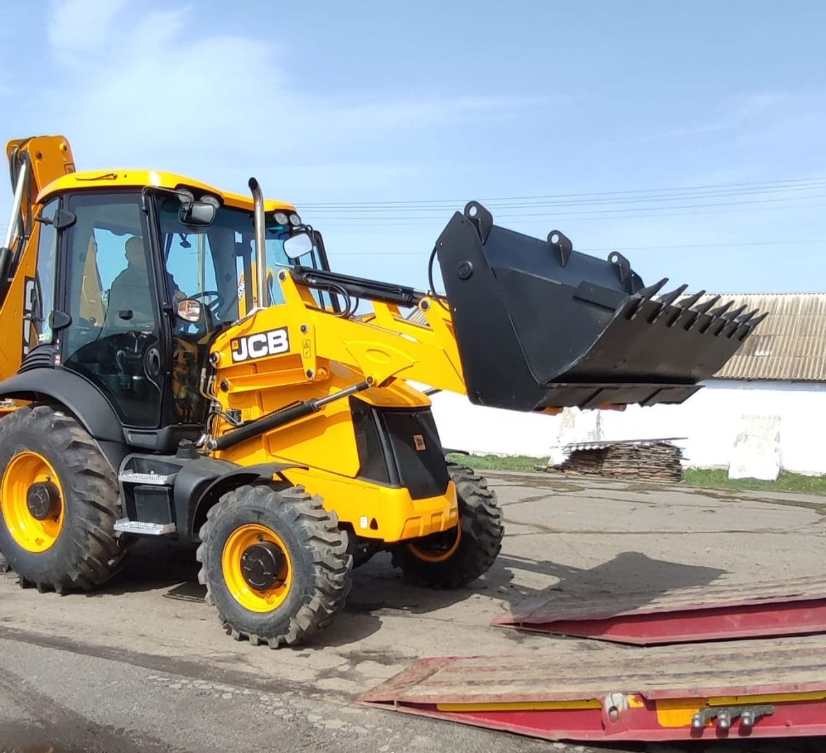 A backhoe loader with load carrying attachment from the USAID DOBRE Program