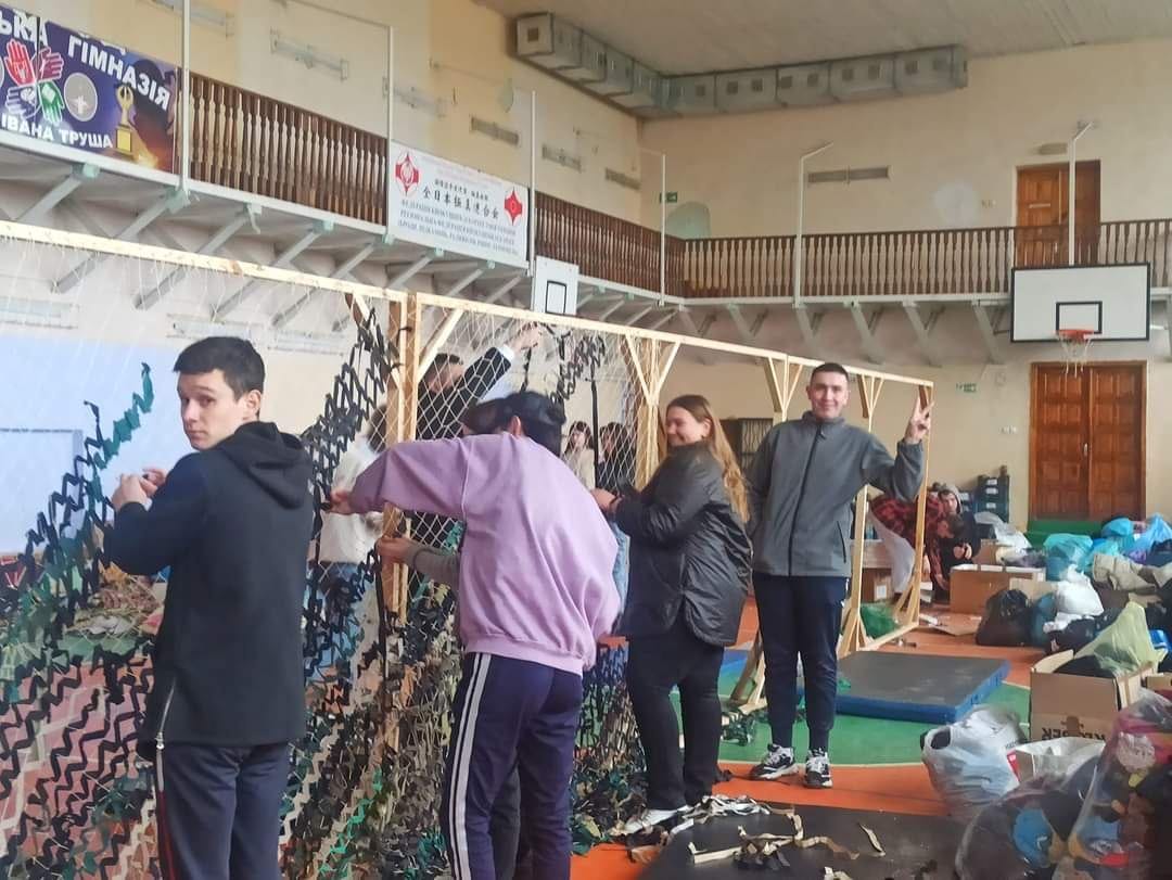 Volunteers weave ghillie suits in the starosta-headed district of the Brody community