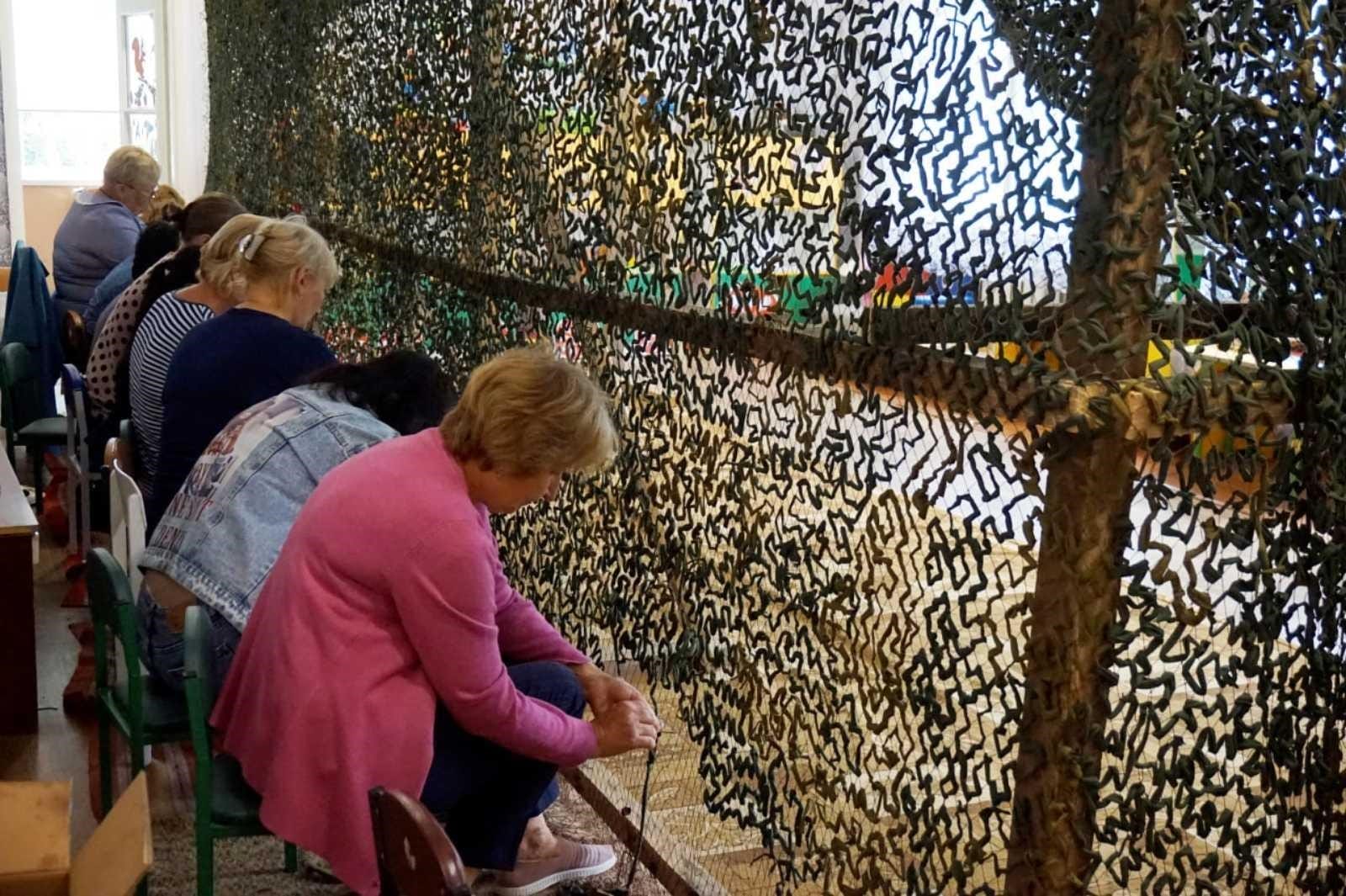 Weaving of camouflage nets by residents of the Hlobyne community