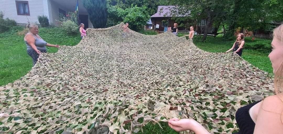 Community volunteers weaving camouflage nets