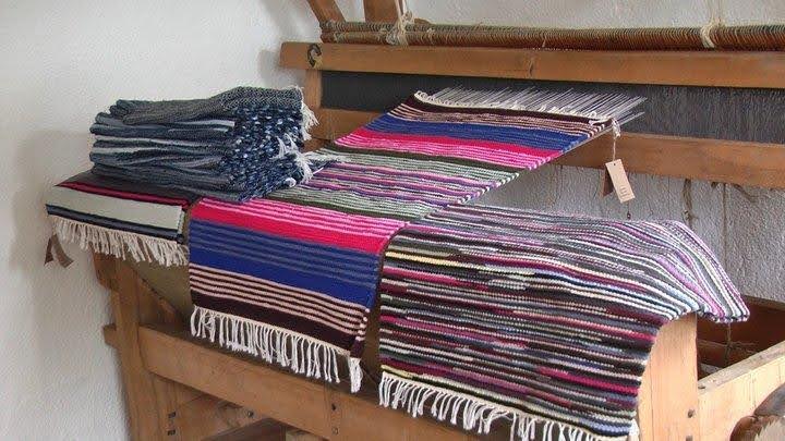 A loom and ready-made cloths in the Vereta Weaving Center