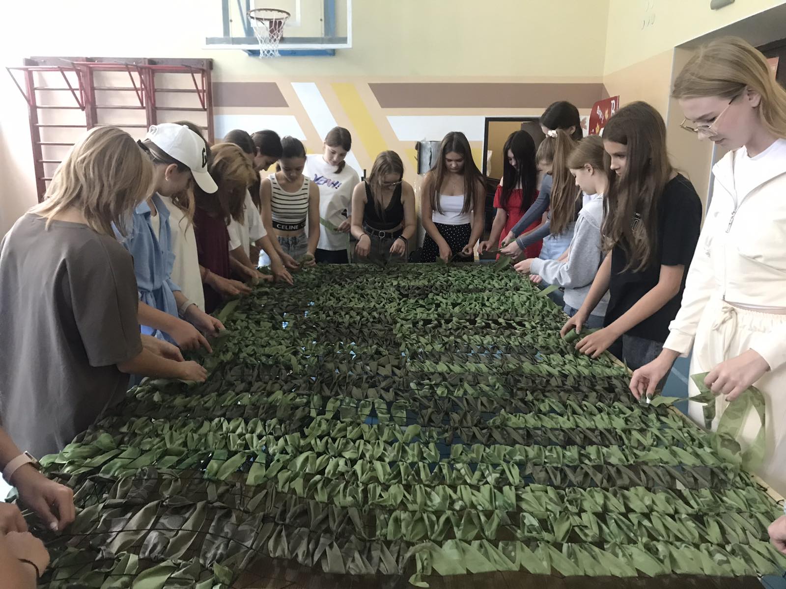 Students of the Yurivka Lyceum weaving camouflage nets for the military