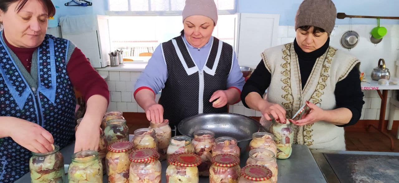 The volunteer team preparing canned meat for the military