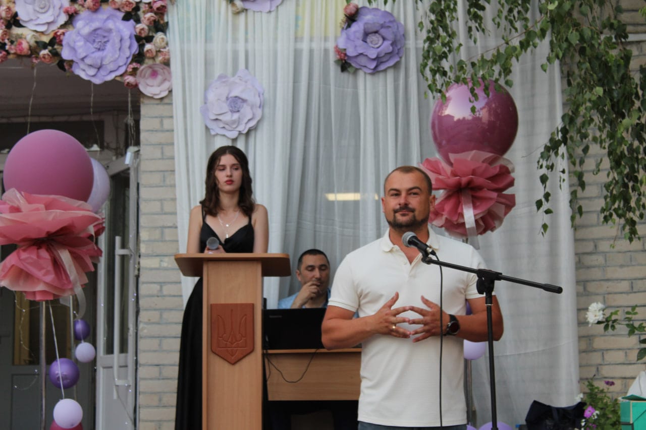 Community leader at a school graduation event