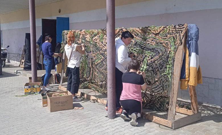 Community volunteers weaving nets near the Volunteer Center in the settlement of Volodymyrets