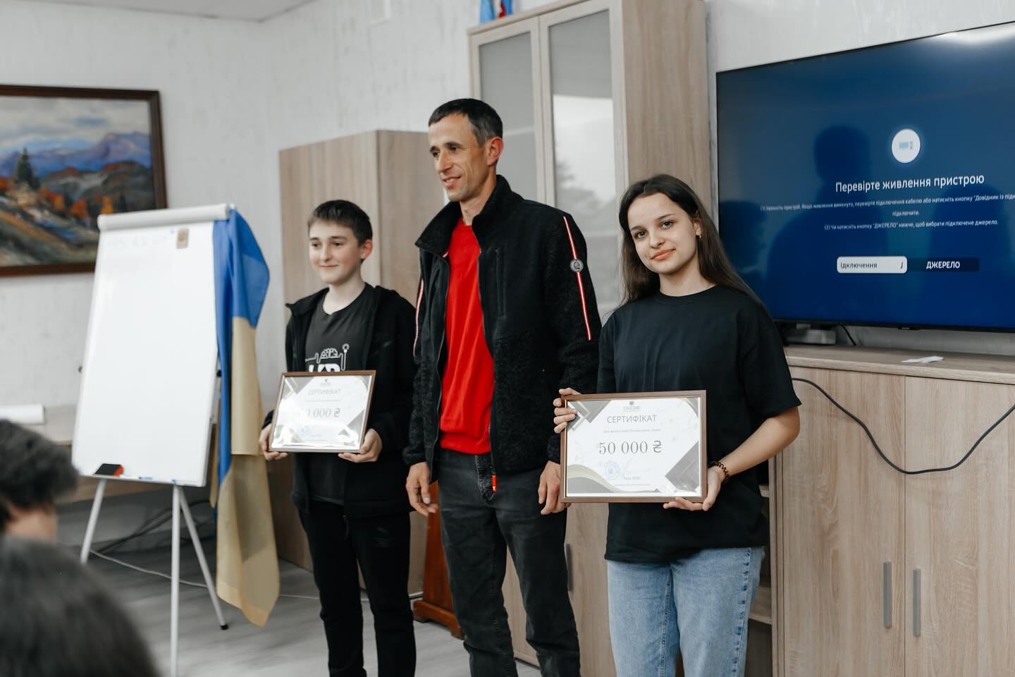 The winners of the project competition together with the head of the community