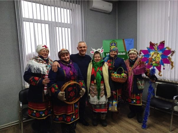 Carolers visiting the head of the community
