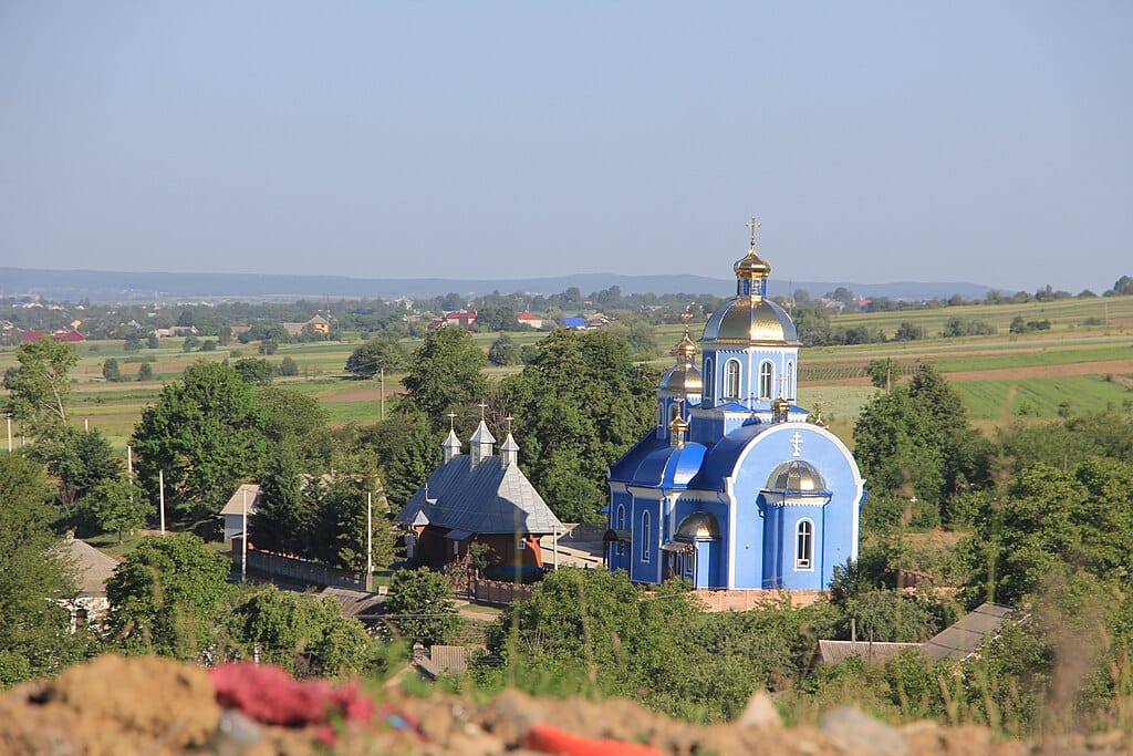 Wooden Church of St. Paraskeva next to the new temple, Horbivtsi village